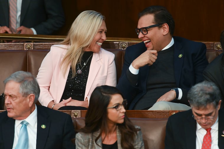 Rep. Marjorie Taylor Greene (R., Ga.) laughs with Rep. George Santos (R., N.Y.) during a vote for speaker of the House earlier this month.