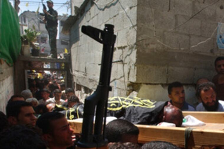 A Palestinian killed during an Israeli army incursion is carried by mourners at his Gaza City funeral. Thirteen Palestinians died in raids that Israel said were aimed at terrorist targets.