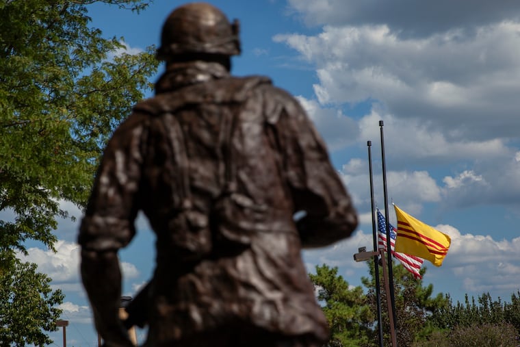 Flags are seen flying at half-mast behind a statue for the late Sen. John McCain at Philadelphia Vietnam Veterans Memorial on Thursday, Aug. 30, 2018. HEATHER KHALIFA / Staff Photographer