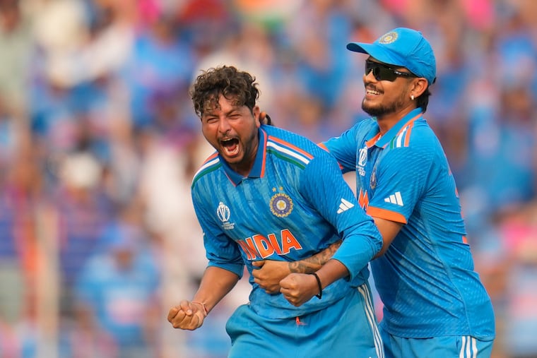 India's Kuldeep Yadav celebrates the wicket of Pakistan's Saud Shakeel during the ICC Men's Cricket World Cup match between India and Pakistan in Ahmedabad, India, on Saturday.
