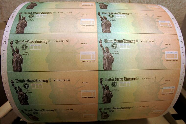 FILE -In this May 8, 2008 file photo, blank U.S. Treasury checks are seen on a roll at the Philadelphia Financial Center, which disburses payments on behalf of federal agencies, in Philadelphia. Millions of older Americans who rely on federal benefits will get a 1.7 percent increase in their monthly payments next year, the government announced Wednesday. It’s the third year in a row the increase will be less than 2 percent. The annual cost-of-living adjustment, or COLA, affects payments to more than 70 million Social Security recipients, disabled veterans and federal retirees. That’s more than a fifth of the country.