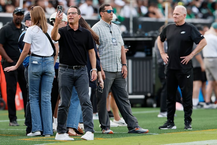 Pennsylvania governor Josh Shapiro shoots a video from the sidelines during an open Eagles practice at Lincoln Financial Field on Tuesday.