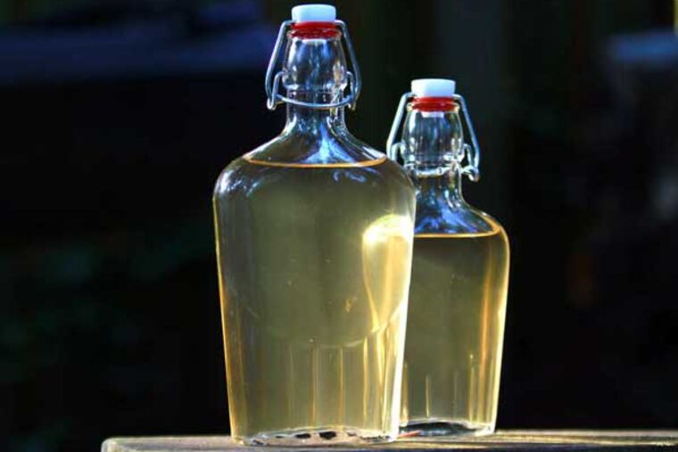 The finished gin is amber rather than clear because the distillation process to remove the color is too dangerous to try at home.