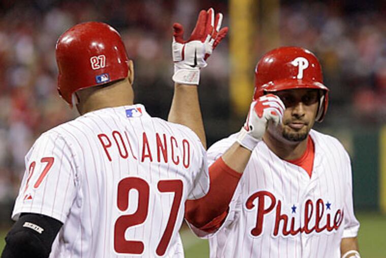 Shane Victorino celebrates his fifth-inning solo home run with Placido Polanco. (Yong Kim/Staff Photographer)