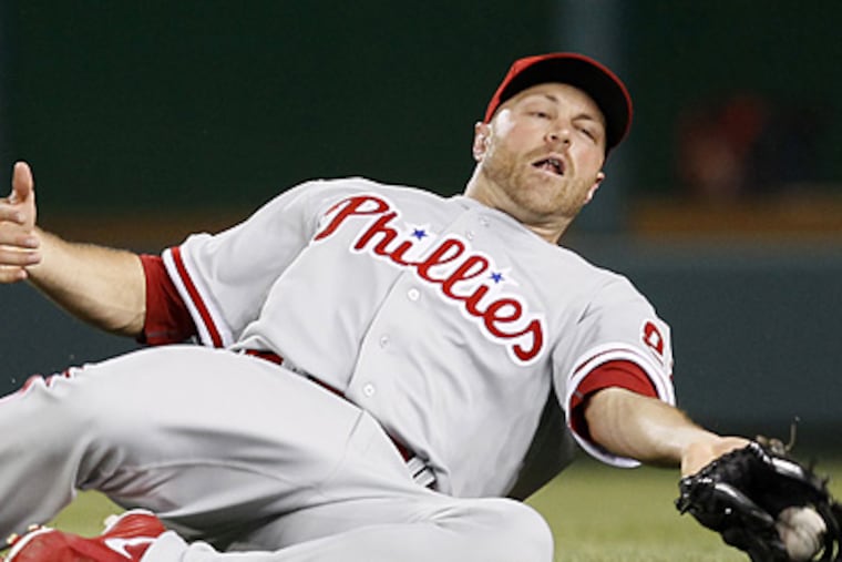 New Phillies right fielder Nate Schierholtz slides to catch a ball in a 3-2 win over the Nationals. (AP Photo/Carolyn Kaster)
