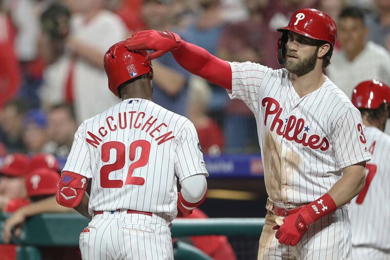 Andrew McCutchen celebrates his two run homer against the Cardinals with teammate Bryce Harper during the 5th inning Wednesday.