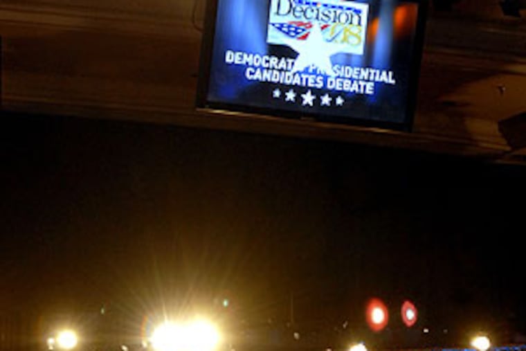 Corneilius de Groot steams the wrinkles out of a backdrop at Drexel University's Main Building. Today, MSNBC will telecast the presidential debate from there live.