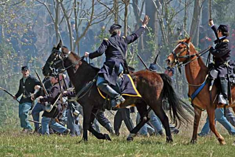 GETTYSOLDIERS30-f - Sirlin on horseback on the right hand, looking away from the camera with his sword in hand, extended to the sky.
The photos are provided courtesy of Jon Sirlin, who is a Philadelphia lawyer, planning to take part in the big Gettysburg reenactment. The photos are generally taken at recent reenactments or living history demonstrations.