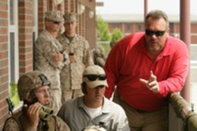 Big-game hunter Greg Williams (right) and fellow consultant Will Atkinson instruct Pfc. Joshua Snell (left) and Cpl. Sean Godfrey.
