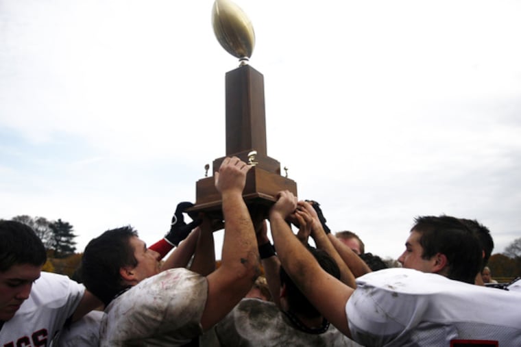 Haddonfield's players hold the Mayor's Trophy high while celebrating their 20-0 victory over Haddon Heights last Thanksgiving. They will play the 100th game in the rivalry's history.