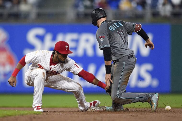 Arizona Diamondbacks' A.J. Pollock, right, slides safely past the tag of Philadelphia Phillies' Pedro Florimon to steal second base during the eighth inning Tuesday night.