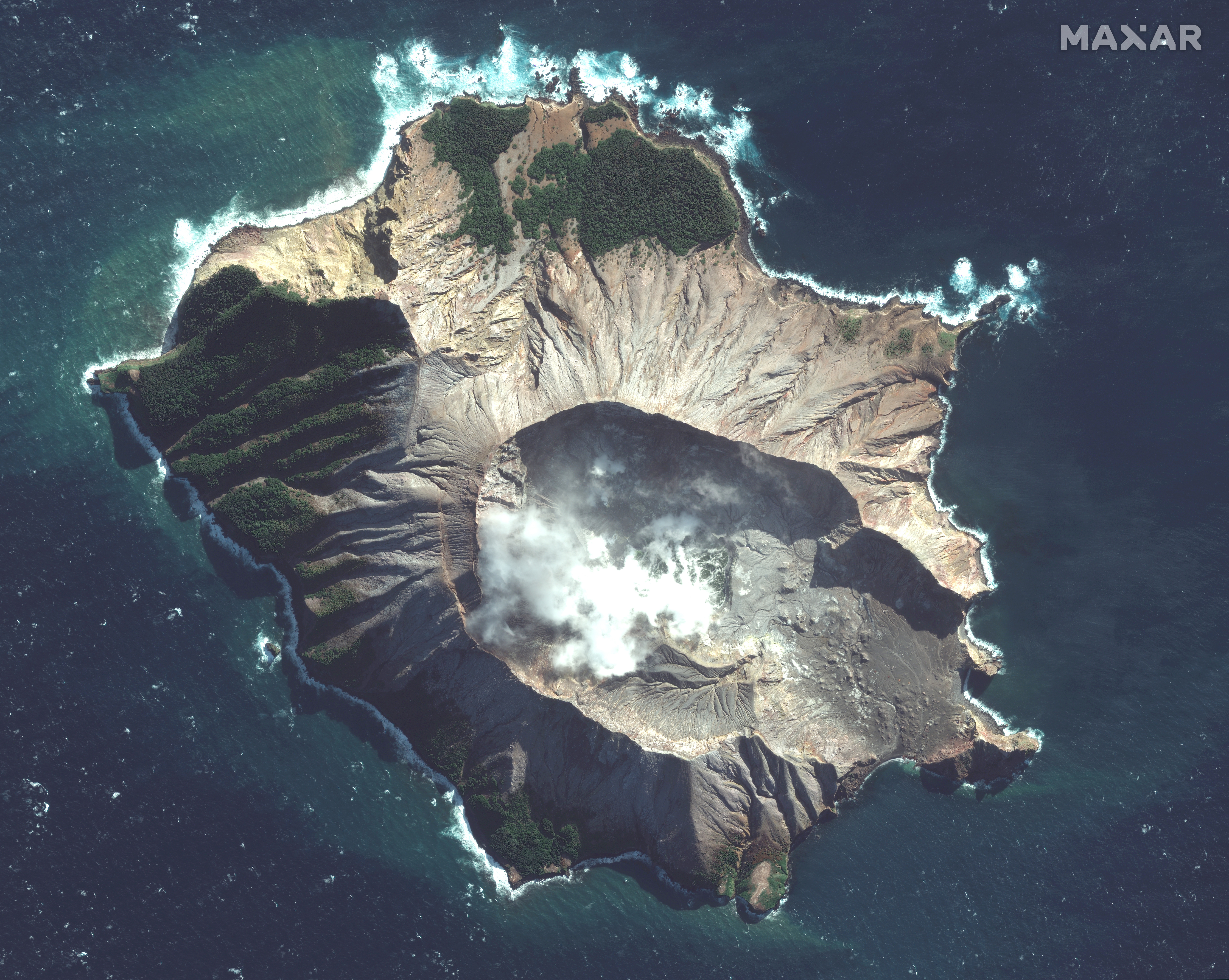In this satellite image, steam rises from the volcano on White Island off the coast of Whakatane, New Zealand.