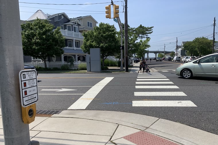 At the corner of Eighth Street and Bay Avenue, an intersection called a "kill zone" by the stepfather of a man fatally struck over Memorial Day weekend. Here, a woman and two children, despite having a white walk signal, are cut off by a car making a left turn from Eighth Street onto Bay Avenue.