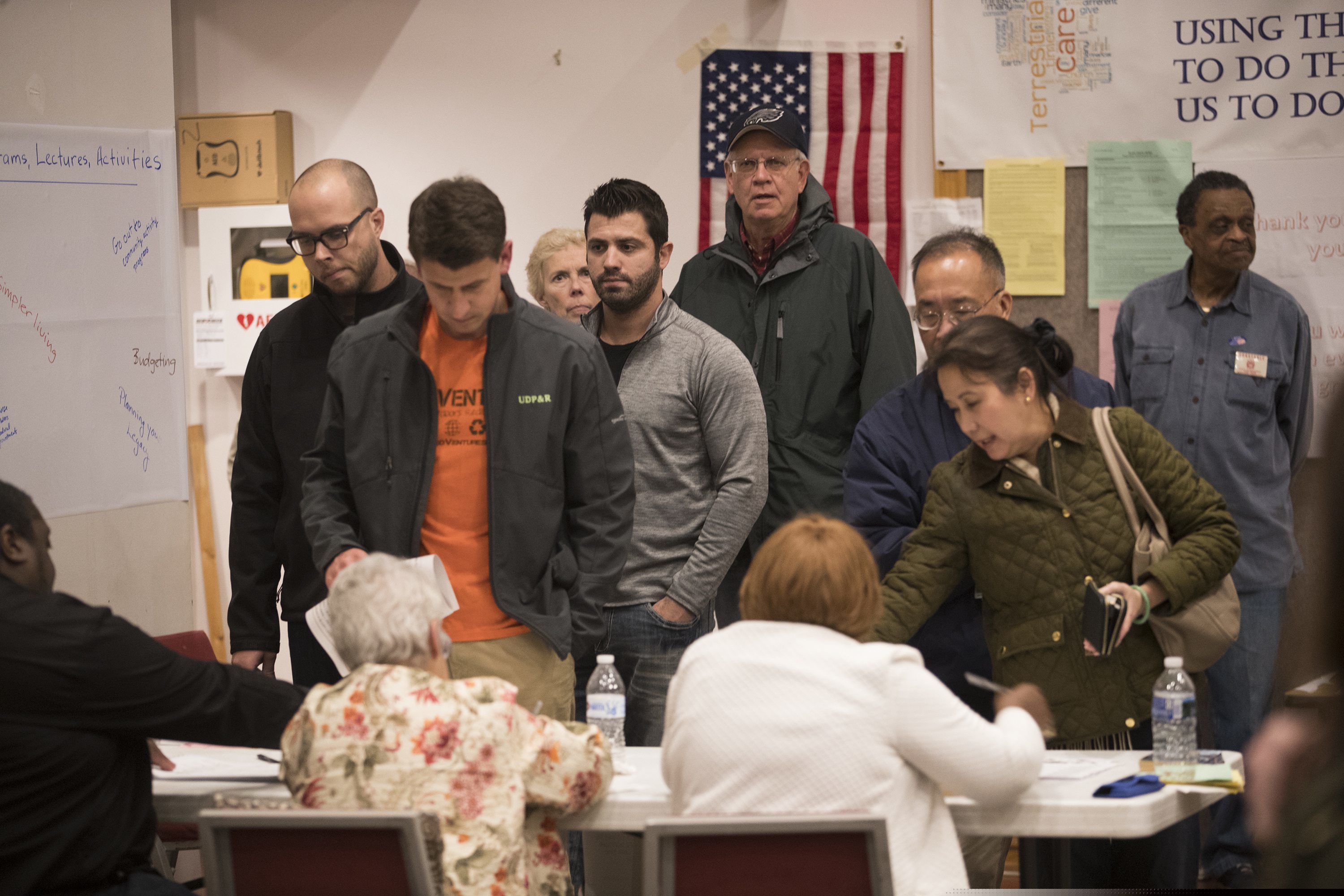 Voters sign in to vote at Trinity Episcopal Church in Ambler, Pa., on Nov. 6, 2018. The county is replacing its voting machines and hopes to have the new ones in place by the May primary, but the federal government shutdown is holding up the process. (Charles Fox/The Philadelphia Inquirer via AP)