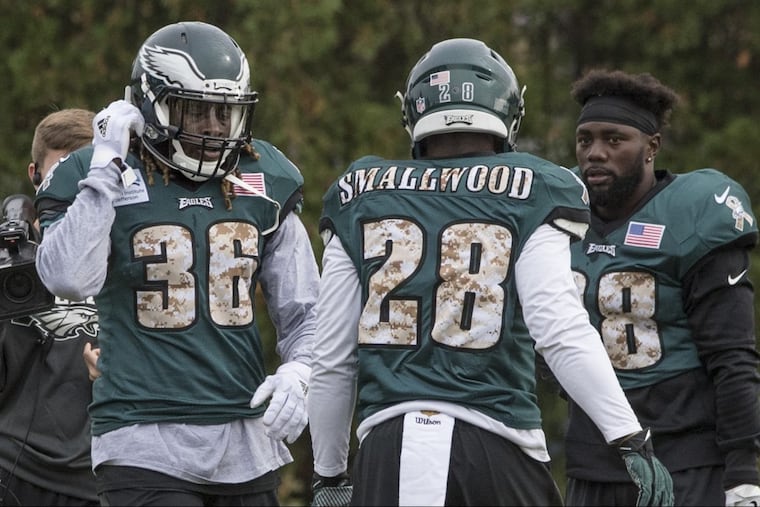 Newly acquired Eagles running back Jay Ajayi (left) walks past running backs Wendell Smallwood and Kenjon Barner during his first practice with the Eagles at the NovaCare Complex November 1, 2017. Ajayi was acquired in a trade with the Miami Dolphins. CLEM MURRAY / Staff Photographer