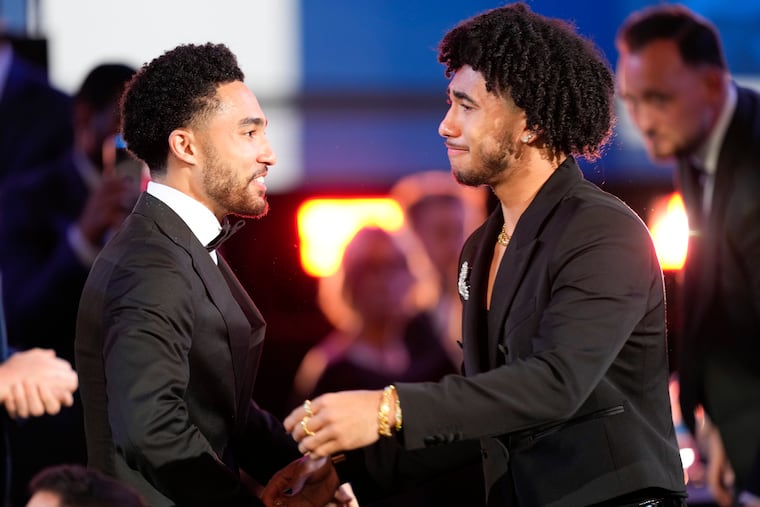 Jared McCain, right, reacts with his brother, Jayce McCain, after being selected 16th by the Philadelphia 76ers during the first round of the NBA basketball draft, Wednesday, June 26, 2024, in New York. (AP Photo/Julia Nikhinson)
