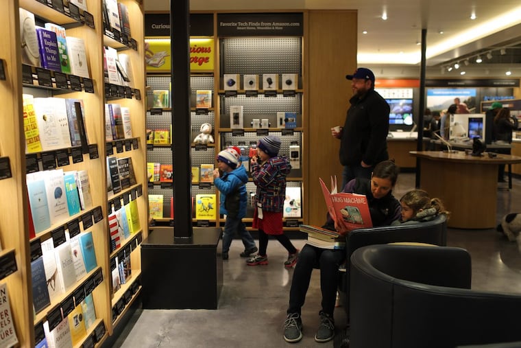 Allyson reads to her daughter Claire during a soft opening of Chicago's first Amazon store on Saturday, March 18.