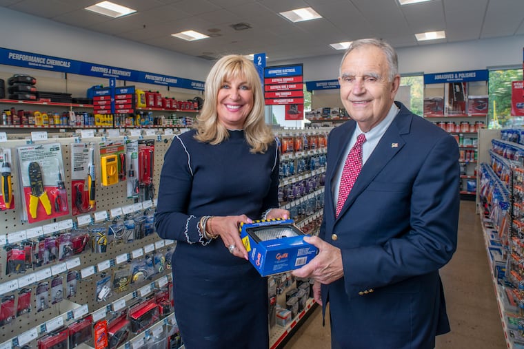 Beth Beans Gilbert and her father Fred Beans, 80, pose for a photograph in one of the aisles of their CarQuest store Tuesday, October 08, 2019. WILLIAM THOMAS CAIN / For The Inquirer