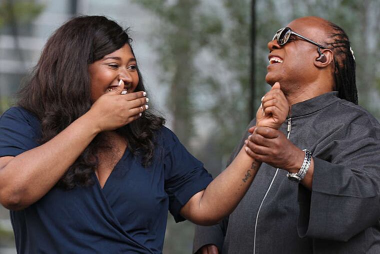 Stevie Wonder, right, thanks Philly singer Jazmine Sullivan after the performed together during a free concert at Dilworth Park in Philadelphia, PA on August 17, 2015. ( DAVID MAIALETTI / Staff Photographer )