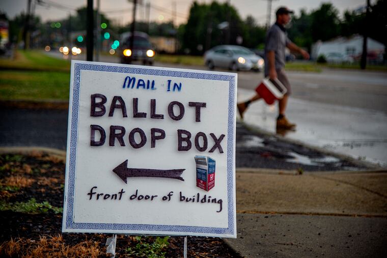 Signs directed voters to a Camden County ballot drop box for mail ballots, at the Audubon Municipal Building on July 6.