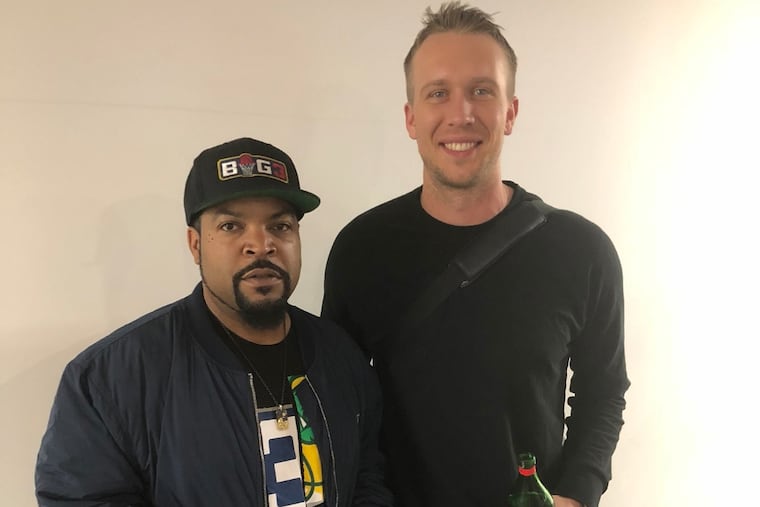 Ice Cube (left)standing next to Eagles quarterback, Nick Foles, who is wearing Swet Tailor top and pant, the unofficial clothing of Eagles off the field. Ice Cube isn't wearing Swet Tailor, he's just cool.