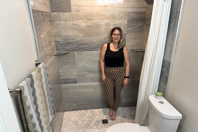 Olney homeowner Renee Blake stands in her newly repaired and renovated bathroom, which she paid for with a loan through Philadelphia's Restore, Repair, Renew program.