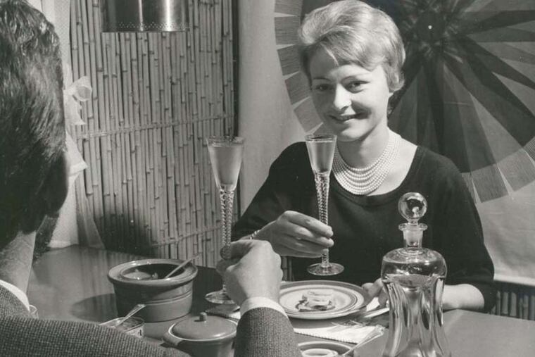 A couple with Aquavit glasses and bottle, circa 1960.
