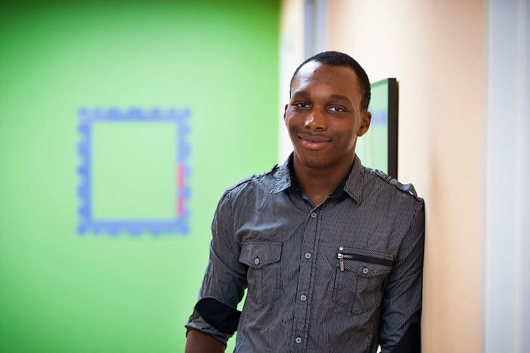 Christian Joynes, 17, a student at Boys Latin of Philadelphia Charter School, stands in the Summer Search offices in Philadelphia on Monday, July 20, 2015. Joynes was nominated by his principal to participate in the Summer Search mentorship program, and recently returned from a trip to Peru. (TRACIE VAN AUKEN/ For the Daily News)