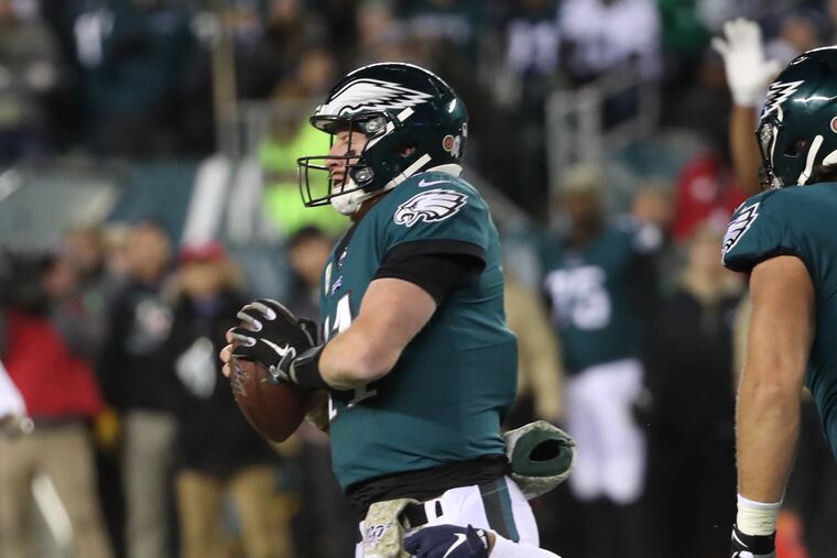 New England linebacker Kyle Van Noy hangs onto to Eagles quarterback Carson Wentz in the second quarter.