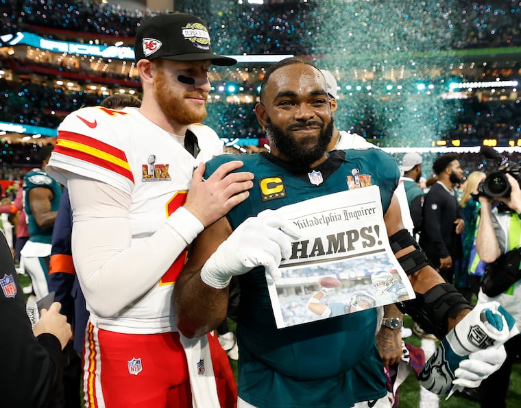 Carson Wentz poses with former Eagles defensive end Brandon Graham after the Eagles beat the Chiefs in Super Bowl LIX.