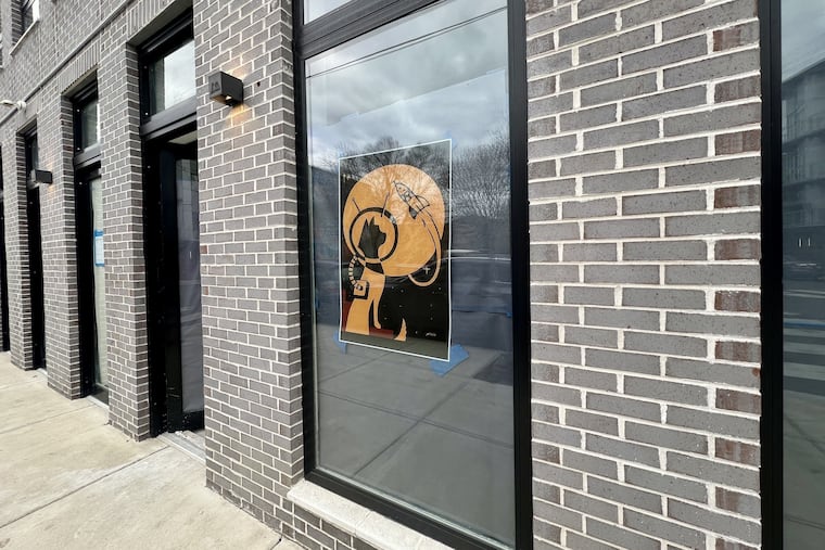 The old Rocket Cat logo on the window of the future LeoFigs, 2201 Frankford Ave., on Nov. 17, 2025.