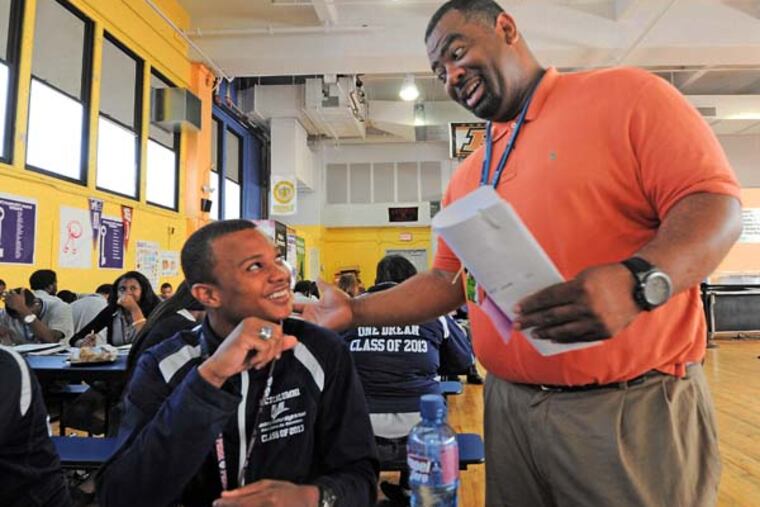 Mastery Thomas School in South Philadelphia on June 12, 3013. Here, in the cafeteria, Dean of Students Dr. Tony Anderson talks to Kevin Beaford, 18, who has just become a Gates Milennium Scholar. ( APRIL SAUL / Staff )