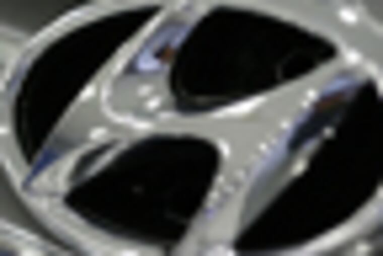 A logo of Hyundai Motor is seen at the company's showroom in Seoul, South Korea, Thursday, Aug. 30, 2012. Hyundai Motor Co. and its labor union reached a tentative agreement Thursday to eliminate night shifts and increase wages, moving one step closer to end the company's first strike in four years. (AP Photo/Lee Jin-man)