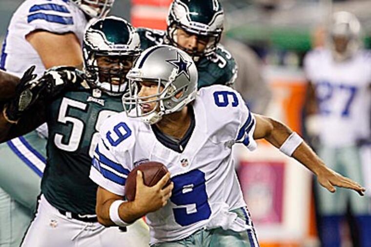 Cowboys quarterback Tony Romo escapes from Eagles defensive end Tent Cole during the third quarter. (Yong Kim/Staff Photographer)