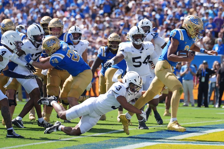 UCLA quarterback Nico Iamaleava scores a rushing touchdown past Penn State cornerback Antoine Belgrave-Shorter (3) during the first half Saturday.