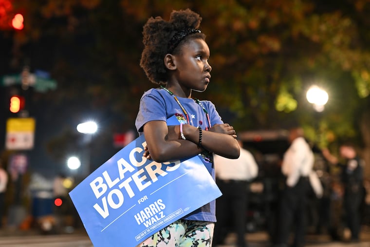A young girl stands outside of Democratic presidential nominee Vice President Kamala Harris' election night watch party at Howard University in Washington.