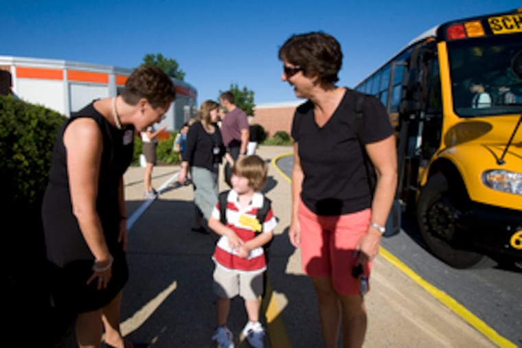 New principal Norma Jean Welsh greets Dylan Raymond, 5, and his mother, Denise, at Brandywine Wallace Elementary.