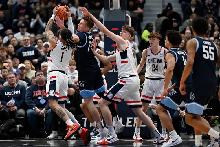 UConn guard Solo Ball grabs a rebound against Villanova forward Duke Brennan on Saturday.