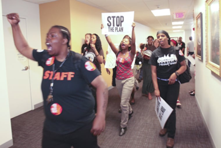 Protesters walk out of the SRC meeting, Thursday, May 31. (Steven M. Falk / Staff Photographer)