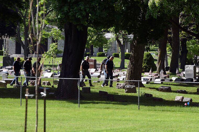 Officers investigate after shots were fired in or near Graceland Cemetery in Racine, Wis.
