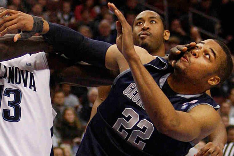 All eyes, but no hands, are on the ball as Villanova's Mouphtaou Yarou battles for a rebound with Georgetown's Julian Vaughn (right) and Austin Freeman.