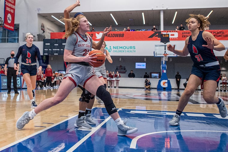 St. Joe's Mackenzie Smith, drives to the basket against Duquesne University, during the Atlantic 10 women's basketball tournament at Chase Fieldhouse.