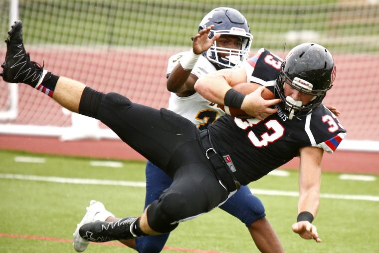 Playing tight end, Tanner Long catches a touchdown pass against West Catholic in October 2016.