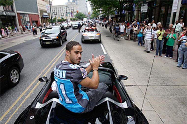Receiver Chris Jackson claps as he rolls along Market Street near 7th Street as the Philadelphia Soul football team celebrated its Arena Bowl Championship with a motorcade along Market Street in Philadelphia on Thursday. The procession ended at City Hall with a victory celebration featuring Jon Bon Jovi. (David Maialetti / Philadelphia Daily News)