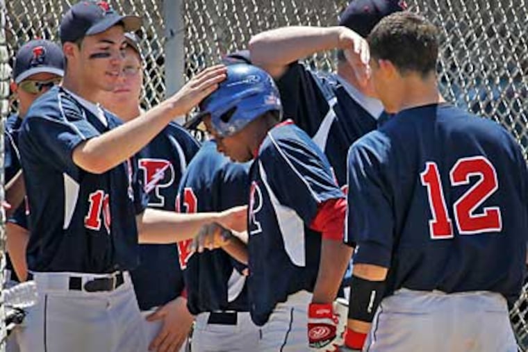 Philadelphia Electric's Elliott Cartillo being congratulated by teammates after scoring in the third inning. (Alejandra A. Alvarez/Staff Photographer)