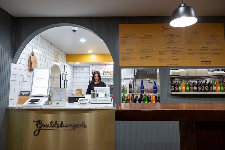 Samantha Sandoz stands behind the counter at Gouldsburgers in Ardmore. The burger restaurant is one of a handful of new businesses that have opened in downtown Ardmore so far this year.