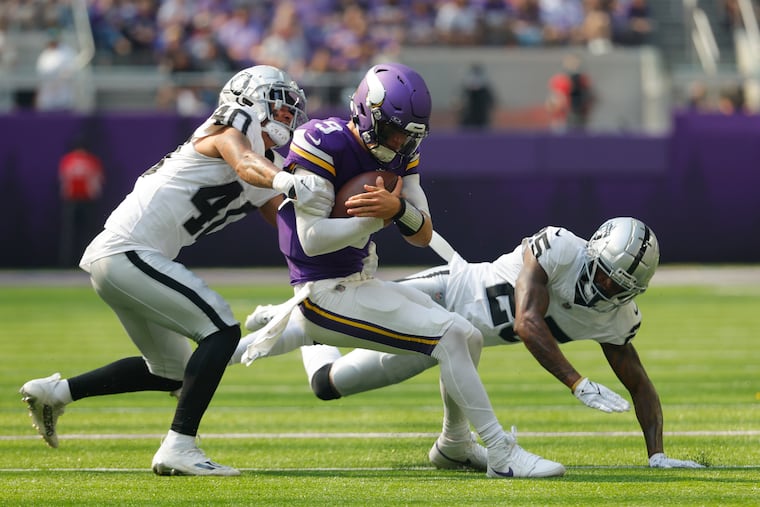 Minnesota Vikings quarterback J.J. McCarthy is hit by Las Vegas Raiders safety Jaydon Grant (40) as he scramble for yards in a preseason game on Saturday.