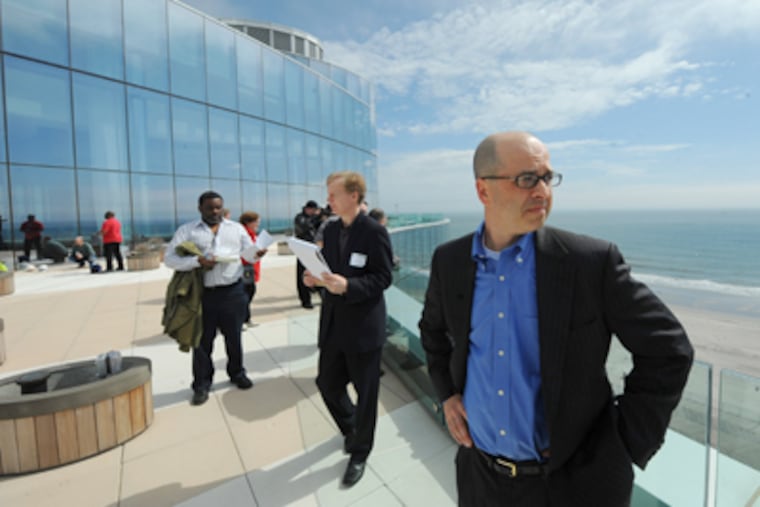Edward J. Cettina, of Tishman Construction Corp., looks out over the Atlantic Ocean from the pool deck of the Revel as he leads journalists on a tour of the new Atlantic City casino Tuesday. (Clem Murray / Staff Photographer)