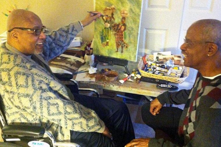 Artist Horace Broughton (left) at work in his Deptford, NJ home with his younger brother, Robert Broughton, of Glassboro, NJ. (Kevin Riordan / Staff)