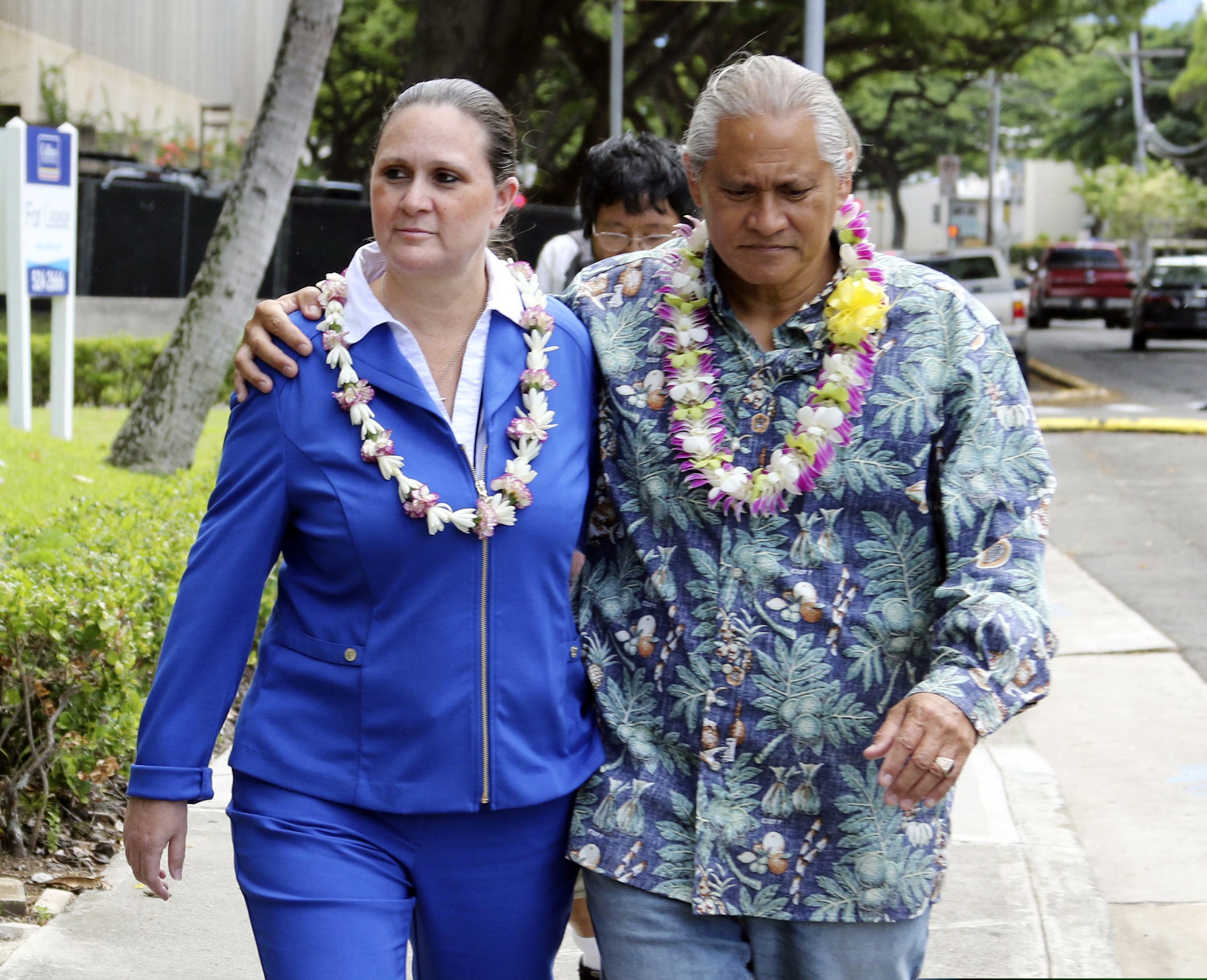 FILE - In this Oct. 20, 2017 file photo, former Honolulu Police Chief Louis Kealoha and his wife Katherine Keahola leave federal court in Honolulu. Kealoha was Honolulu's Rolex-wearing police chief and his wife Katherine was the Maserati-driving prosecutor in charge of a unit targeting career criminals. Prosecutors say the couple funded a lavish lifestyle by defrauding banks, relatives and children. They're heading to trial in May 2019 on charges they orchestrated the framing of a relative for a mailbox theft who threatened to expose their fraud. (AP Photo/Caleb Jones, File)